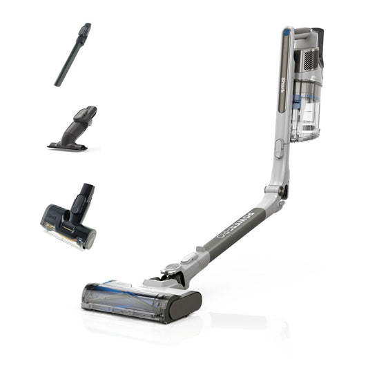 Shark cordless stick vacuum in Java Metallic with detachable motorised floorhead and three accessory tools arranged nearby.