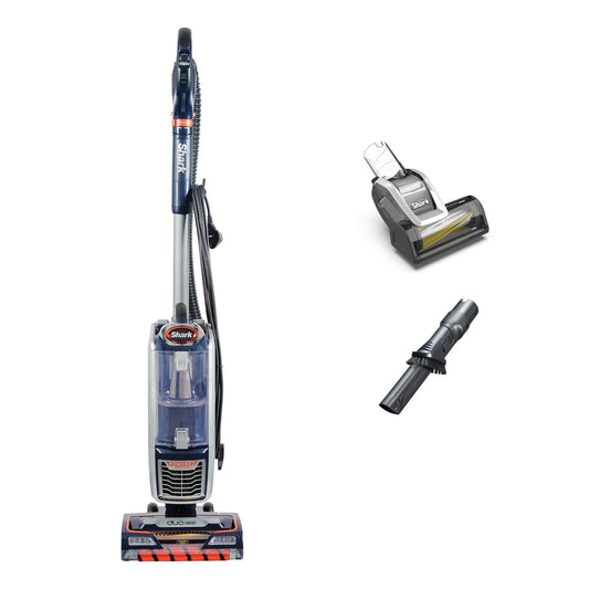 Shark upright vacuum with clear dust cup, shown beside a motorised pet tool and a crevice/dusting brush on a white backgro…