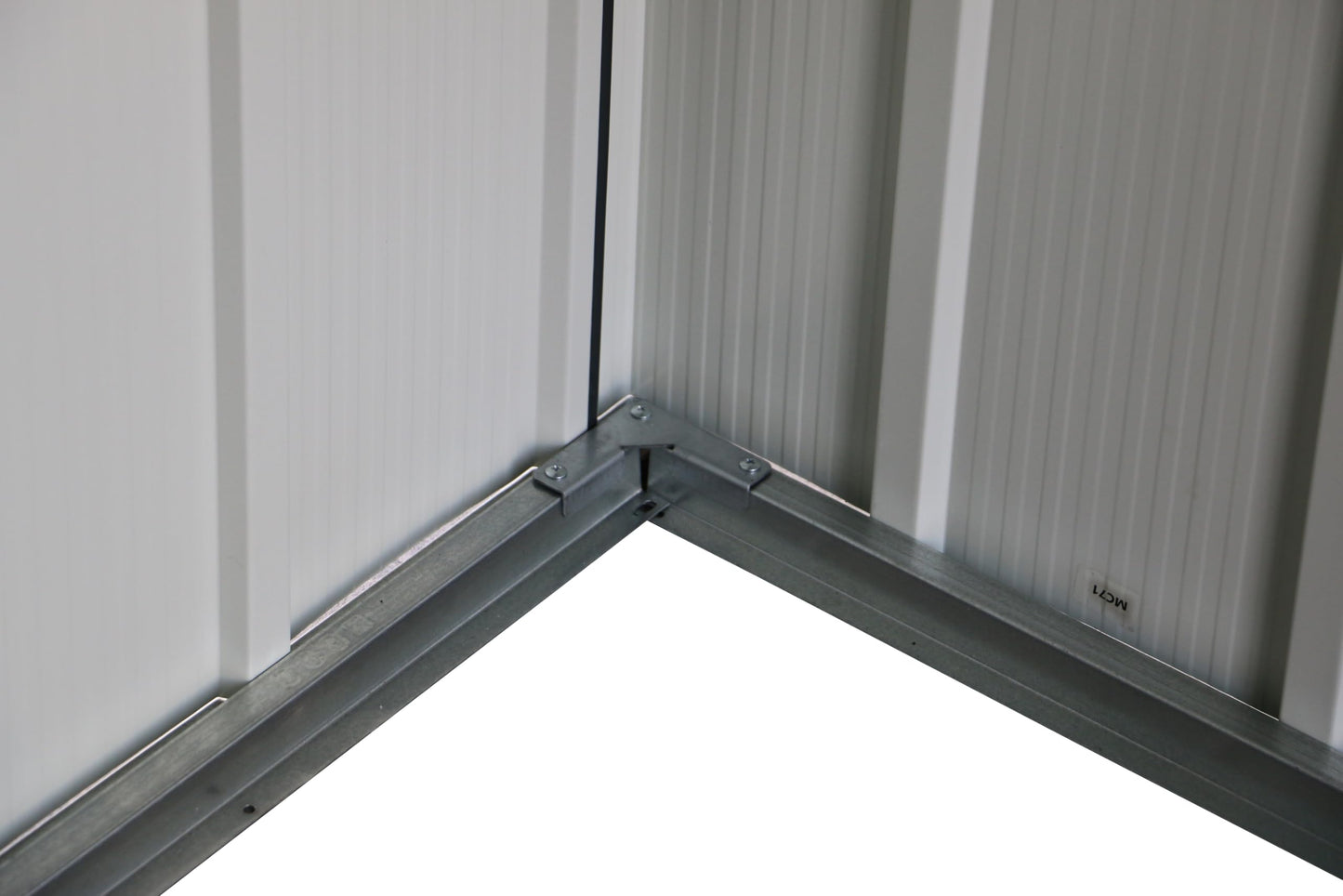 Close-up of a dark metal handle mounted on the sliding shed door
