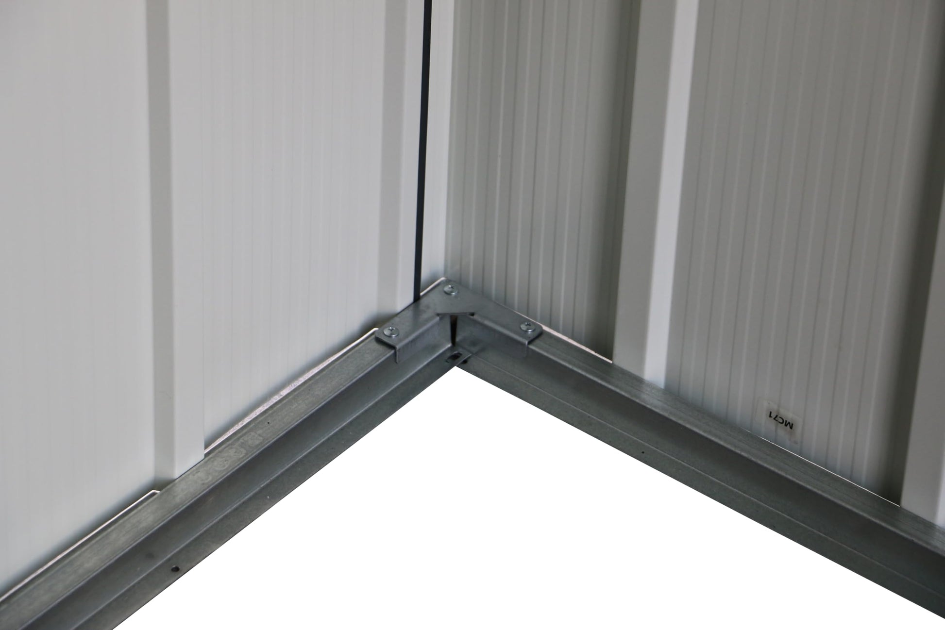 Close-up of a dark metal handle mounted on the sliding shed door