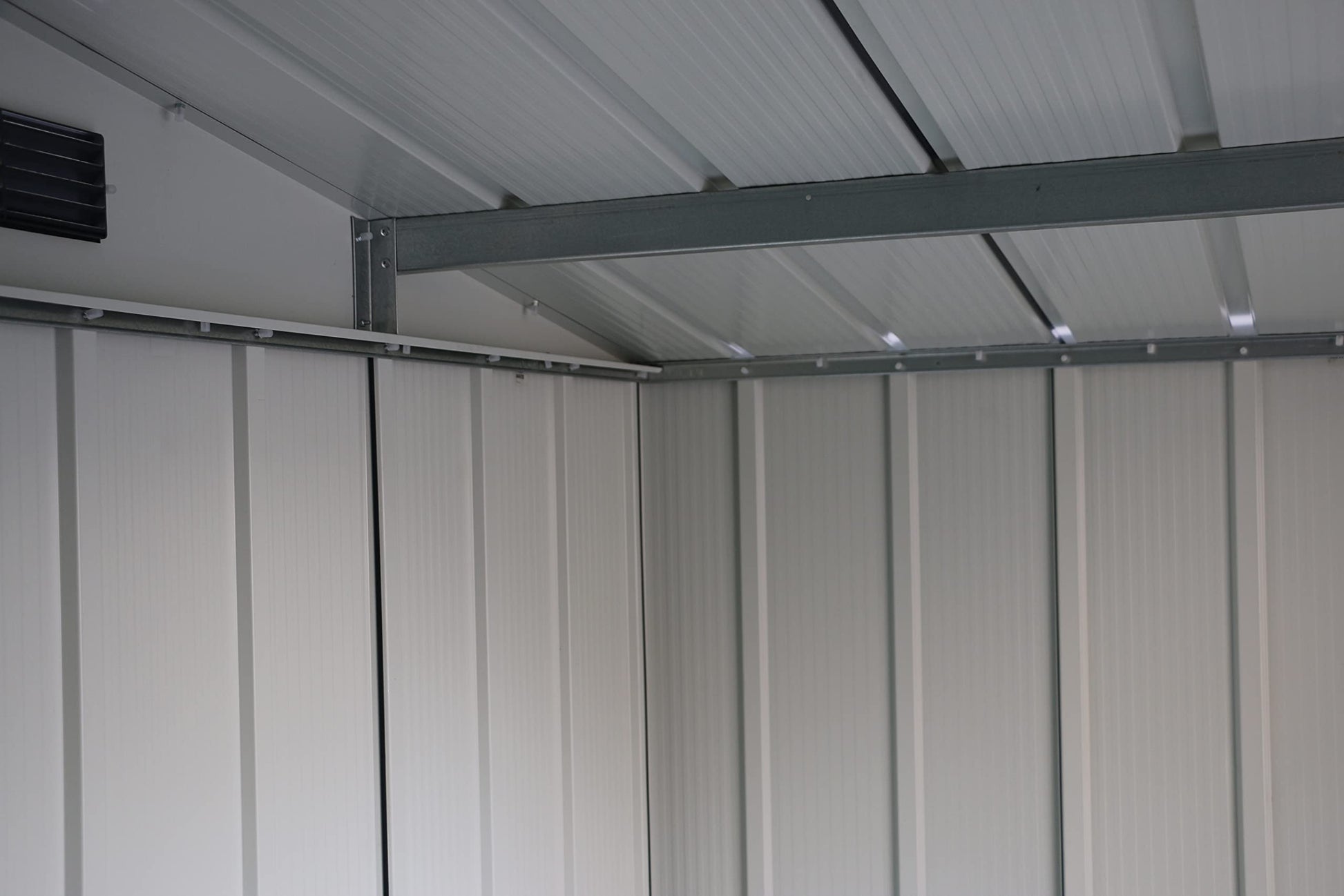 Interior view of the roof showing steel rafters, ribbed metal panels and upper gable vents
