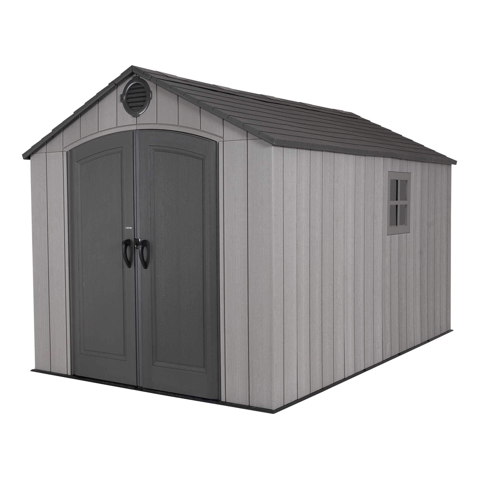 Close-up of storm dust grey shed front corner with dark double doors, circular gable vent and high‑pitched roof.