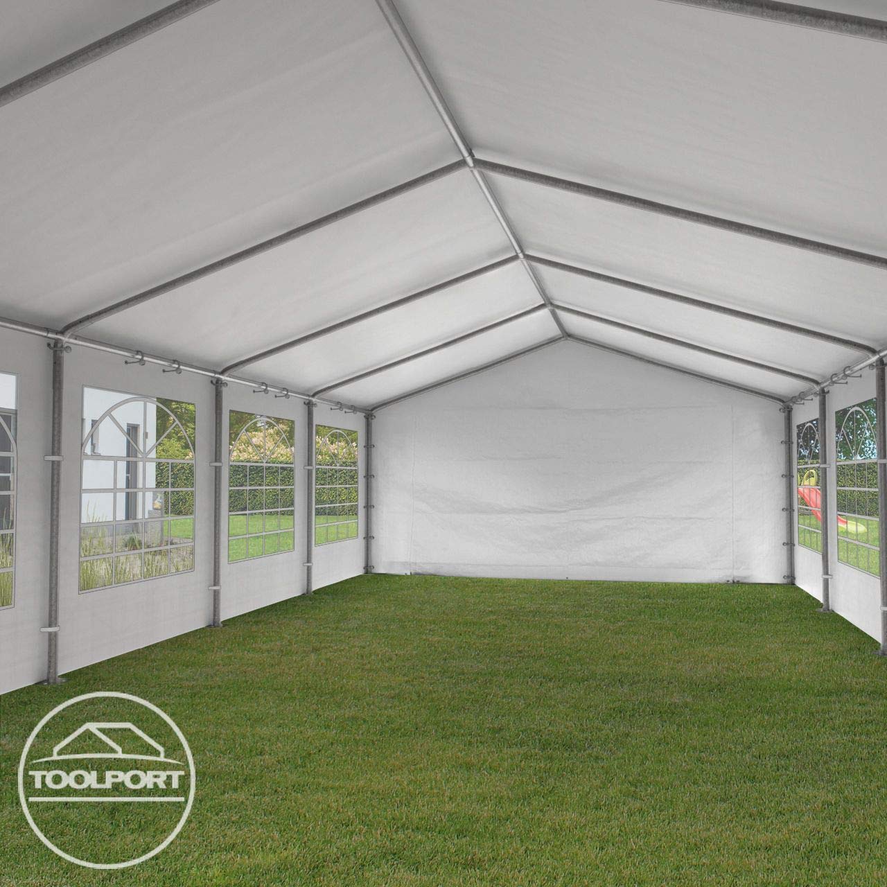 Interior view of the marquee showing galvanized roof beams, side windows and grass floor