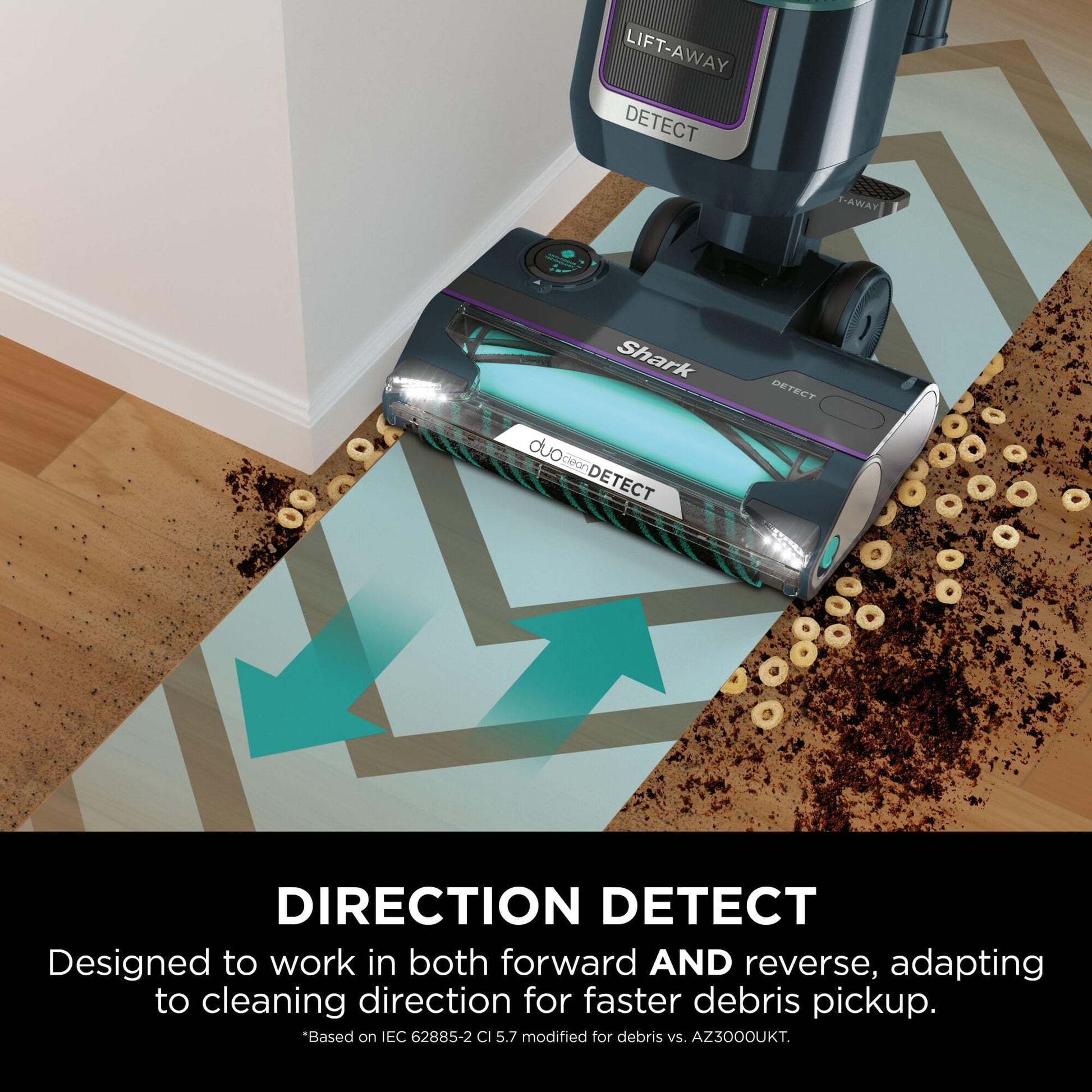 Vacuum head cleaning spilled cereal and dirt at a room edge, showing LED lights and the brushroll