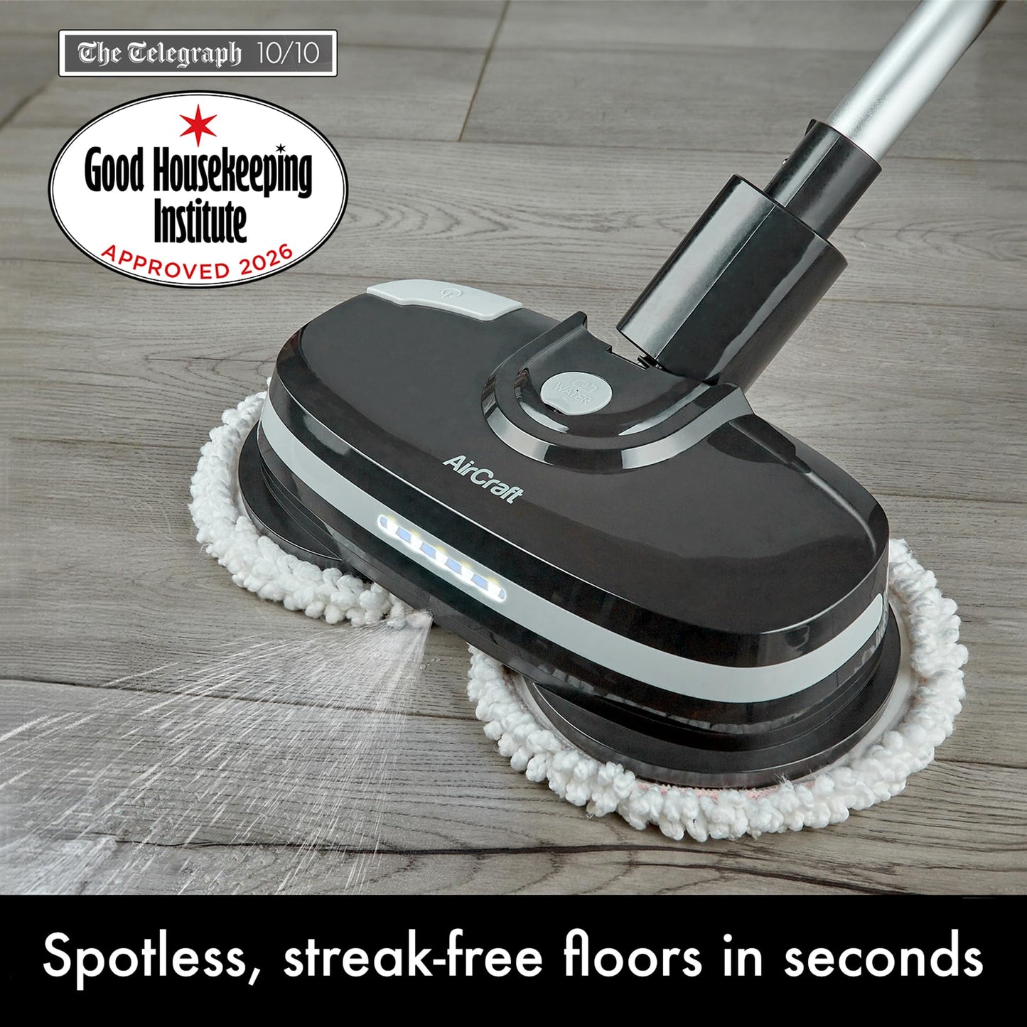 Close-up of PowerGlide head on wood floor showing LED lights, water spray and Good Housekeeping approval badge