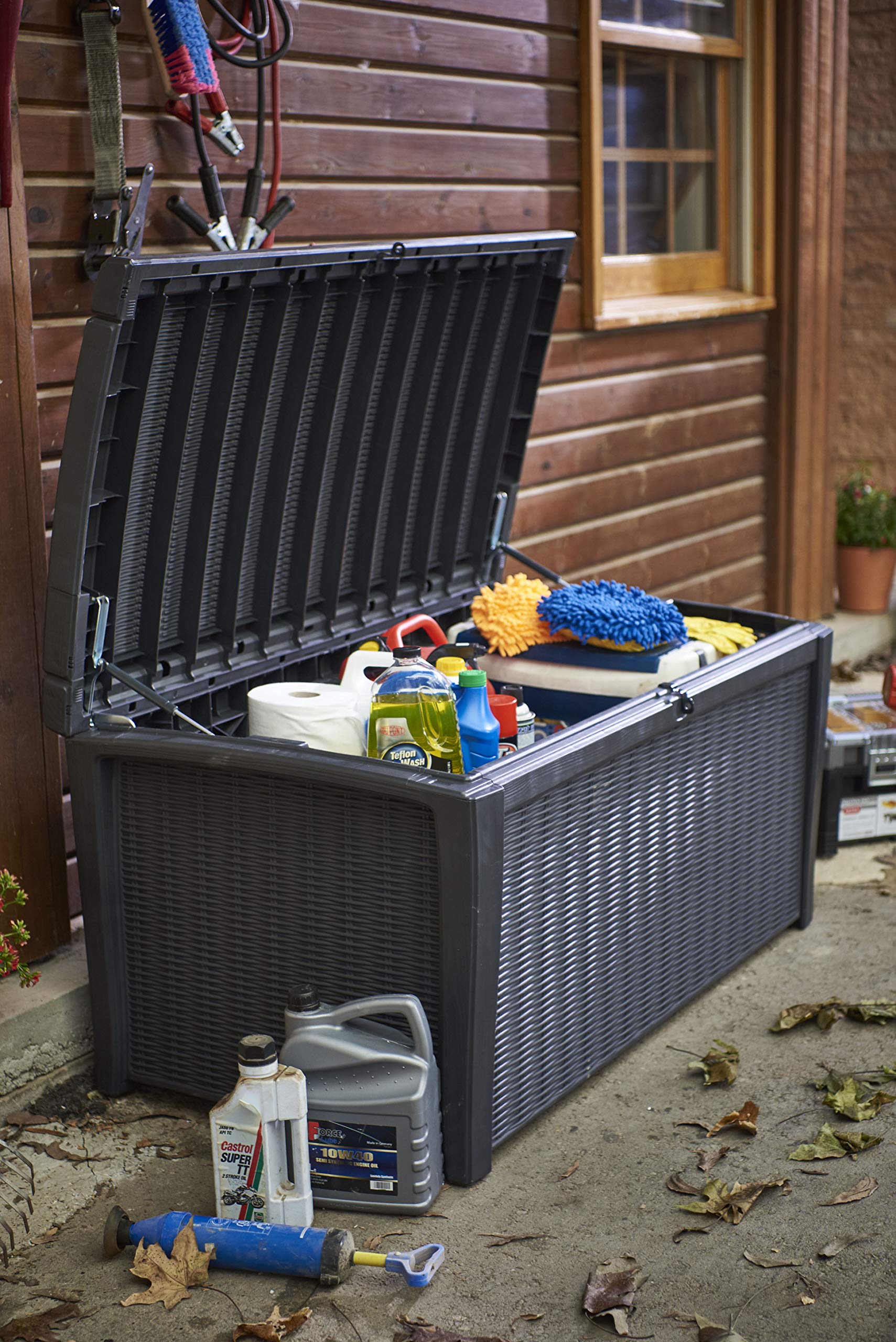 Three-quarter front view of closed grey rattan-effect garden storage box