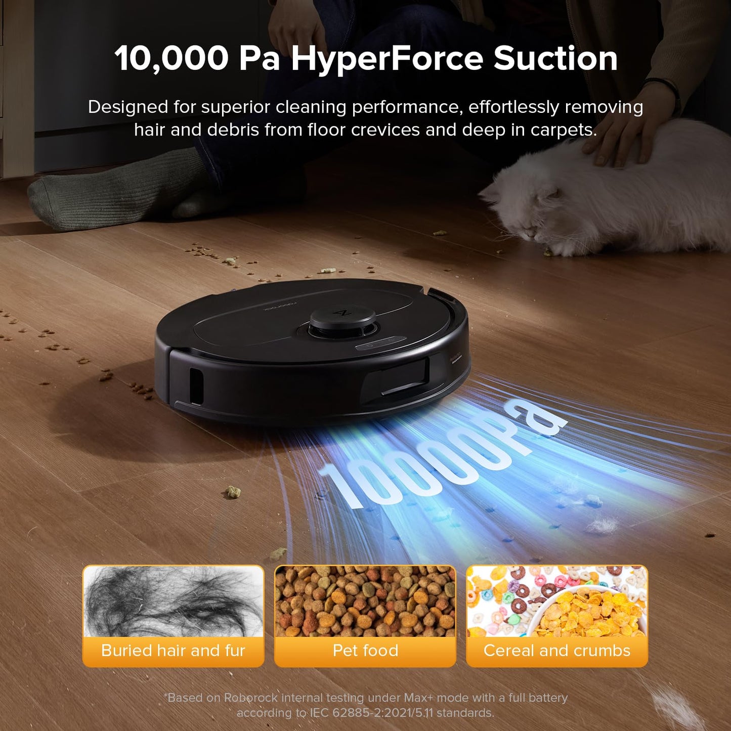 Robot vacuum picking up scattered crumbs on hardwood floor with a person’s legs and a white cat nearby; ‘10000Pa’ suction …